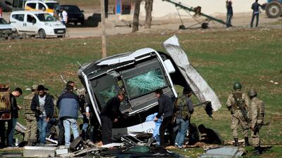 Turkish security forces stand next to a military vehicle damaged in bomb blast near Diyarbakir on February 18, 2016, that killed seven soldiers. Sertac Kayar / Reuters