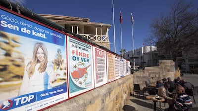 People sit next to campaign posters for parliamentary elections at a cafe in the northern part of Nicosia in the self-proclaimed Turkish Republic of Northern Cyprus, which is only recognized by Turkey. Birol Bebek / AFP