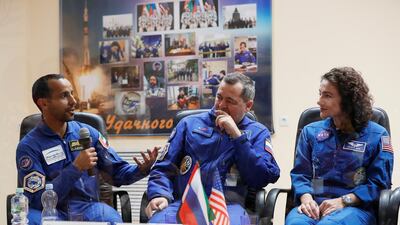 The trio answer questions in a mixture of languages - all must learn Russian for the mission - for the media. Shamil Zhumatov / Reuters