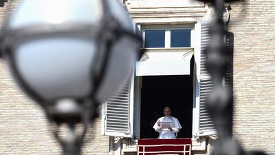 Pope Francis waves as he arrive to deliver his message to pilgrims gathered on St. Peter's square, during his Angelus Sunday prayer at the Vatican. Vincenzo Pinto / AFP Photo
