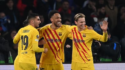 Barcelona's Gabonese midfielder Pierre-Emerick Aubameyang (C) celebrates with teammates after scoring his team's fourth goal during the UEFA Europa League knockout round play-off second leg football match between SSC Napoli and FC Barcelona at the Diego Armando Maradona Stadium in Naples on February 24, 2022. (Photo by ANDREAS SOLARO / AFP)