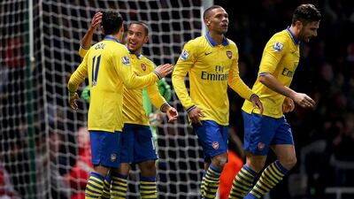 Arsenal players like Theo Walcott, second from left, and Mesut Oezil, left, could change the fortunes for their club in 2014 and finally hoist a trophy. Ian Walton/Getty Images