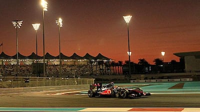 Lewis Hamilton drives through the setting sun in Abu Dhabi to win at the Yas Marina Circuit ahead of Fernando Alonso, the Ferrari driver, and Mark Webber's Red Bull.