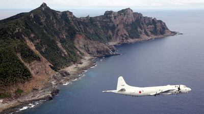 A Japanese patrol plane flies over the disputed islets known as the Senkaku islands in Japan and Diaoyu islands in China, in the East China Sea. (AFP PHOTO)