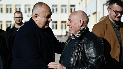 GERB party leader Boyko Borisov (L) speaks to a voter outside a polling station in Sofia on Sunday. AFP