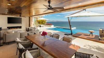The indoor and outdoor living spaces blend into terraces and infinity pools.