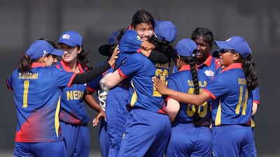 Nepal's Krishma Gurung celebrates with teammates after taking the wicket of the UAE opener Emily Thomas for a duck.