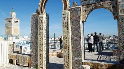 Tourists take pictures as they tour the medina, the old city of Tunis. Tunisia, the cradle of the Arab Spring, wants to revive its battered tourism industry more than two years after the revolution. Zoubeir Souissi / Reuters