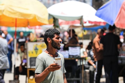 A Palestinian man sells single cigarettes as soaring prices have make them unaffordable for most smokers to buy by the pack, at a market in Nuseirat, Gaza. AFP
