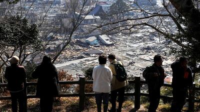 Survivors of the tsunami that devasted the Fukushima nuclear plant look over the remains of Ishinomaki in Miyagi Prefecture, about 270km north of Tokyo. Japan is facing a choice over the future of its energy policy. Kimimasa Mayama / EPA