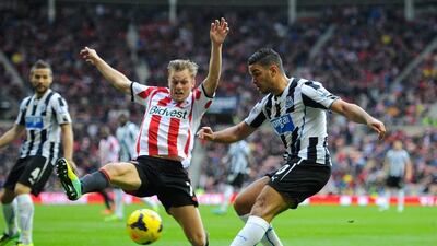 Newcastle's Hatem Ben Arfa, right, crossing under pressure from Sebastian Larsson of Sunderland. The hosts defeated Newcastle 2-1 on Sunday to move off the foot of the table. Stu Forster / Getty Images