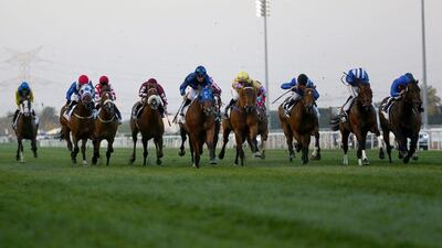Jockeys compete in the Al-Quoz sprint during the Dubai World Cup horse racing event on March 26, 2016 at the Meydan racecourse in the United Arab Emirate of Dubai. / AFP / MARWAN NAAMANI