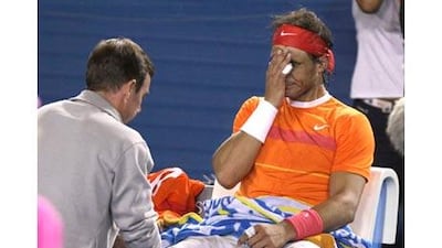 Rafael Nadal receives medical treatment during the third set against Andy Murray. The Spaniard was forced to retire from the Australian Open.