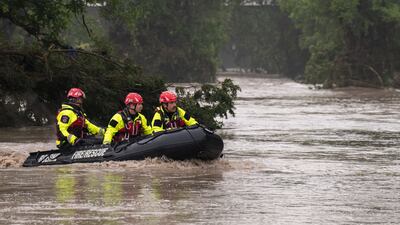 Rescuers search for survivors in an inflatable boat on the flooded Guadalupe river in Comfort, Texas. Getty Images