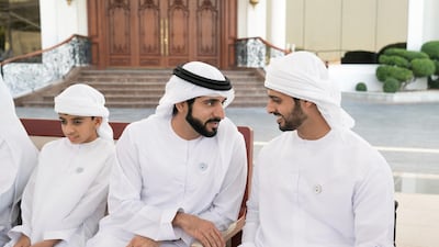 Sheikh Hamdan bin Mohammed, Crown Prince of Dubai, speaks with Sheikh Zayed bin Hamdan, during a Sea Palace barza. Seen with Sheikh Rashid bin Hamdan bin Zayed Al Nahyan (L). Mohammed Al Hammadi / Crown Prince Court - Abu Dhabi