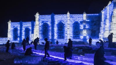 Chinese labourers work on an ice sculpture in preparation for the Harbin Ice and Snow Festival in Harbin, China. Getty Images
