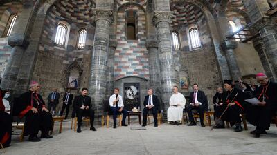 French President Emmanuel Macron (C-L) speaks with priests during a tour of the Our Lady of the Hour Church in Iraq's second city of Mosul, in the northern Nineveh province, on August 29, 2021. (Photo by AFP)