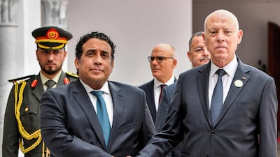 Tunisia's President Kais Saied, right, receives Libyan Presidential Council chairman Mohamed Al Menfi at Tunis-Carthage International Airport. AFP