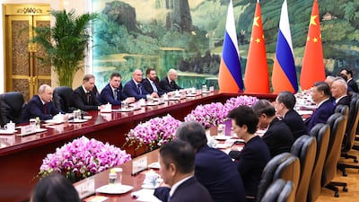 Mr Putin, left, and Mr Xi, fourth from right, meeting in Beijing. EPA