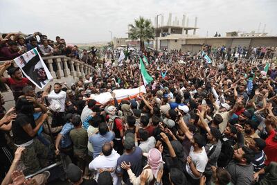 Mourners attend the burial of Syrian rebel Abdelbaset Sarout in Al Dana, Idlib province, on June 9, 2019. AFP