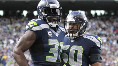 Seattle Seahawks' Kam Chancellor, left, and KJ Wright, right, celebrate during their team's NFL win against the St Louis Rams on Sunday. John Froschauer / AP / December 28, 2014