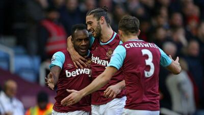 West Ham's two goal-scorers Michail Antonio, left, and Andy Carroll, centre, celebrate Antonio's opener against Liverpool. Justin Tallis / AFP