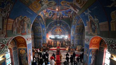 Members of the congregation listen during a service of the Nativity of Christ Liturgy at the Serbian Orthodox Church of the Holy Prince Lazar in Birmingham, on Friday. Orthodox Christians celebrate Christmas according to the Julian calendar, with Christmas Day falling on January 7. AFP