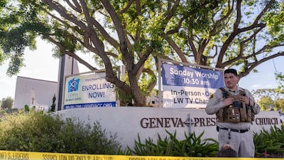 An Orange County Sheriff's Department officer guards the grounds of Geneva Presbyterian Church. AP