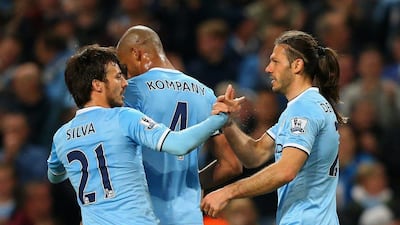 Martin Demichelis of Manchester City, right, celebrates with David Silva and Vincent Kompany as he scores their third goal on Monday night. Alex Livesey / Getty Images / April 21, 2014