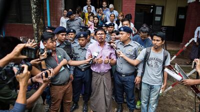 Detained Reuters journalist Wa Lone talks to media while being escorted by police as he leaves the court after his trial hearing in Yangon, Myanmar, 02 July 2018. EPA