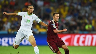 Viktor Fayzulin of Russia is challenged by Nabil Bentaleb of Algeria during their match on Thursday at the 2014 World Cup in Curitiba, Brazil. Matthias Hangst / Getty Images