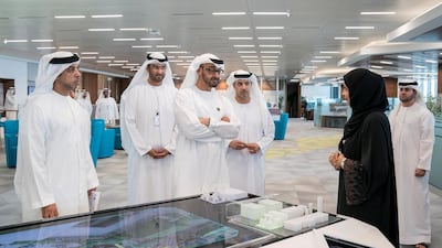 Sheikh Mansour bin Zayed Al Nahyan, UAE Deputy Prime Minister and Minister of Presidential Affairs (L), Sheikh Mohamed bin Zayed Al Nahyan, Crown Prince of Abu Dhabi and Deputy Supreme Commander of the UAE Armed Forces (3rd L) and Sheikh Hazza bin Zayed Al Nahyan, Vice Chairman of the Abu Dhabi Executive Council (4th L), visit the Panorama Digital Command Centre, after attending a Supreme Petroleum Council meeting, at the Adnoc) headquarters. Seen with Dr Sultan Ahmed Al Jaber, UAE Minister of State, Chairman of Masdar and CEO of ADNOC Group (2nd L) and Dr Ahmed Mubarak Al Mazrouei, Secretary General of the Abu Dhabi Executive Council (back R). ( Mohamed Al Hammadi / Crown Prince Court - Abu Dhabi ) ---
