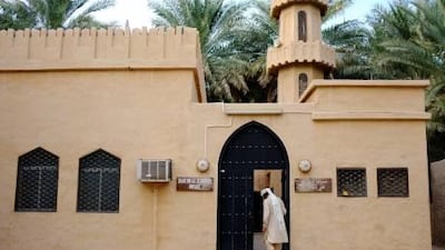 A worshipper enters the Obaid Bin Ali Al Nasseri Mosque, the smallest of the three houses of prayer in the Al Ain Oasis.