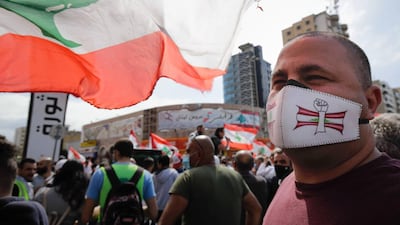 A protester wearing a face mask looks on as he attends a demonstration in Al Nour Square, Tripoli. AFP