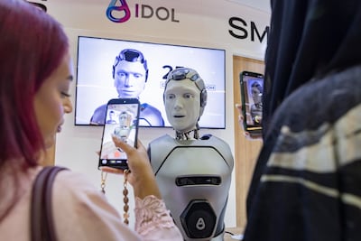 An AI humanoid interacting with AIM Congress visitors. Antonie Robertson/The National