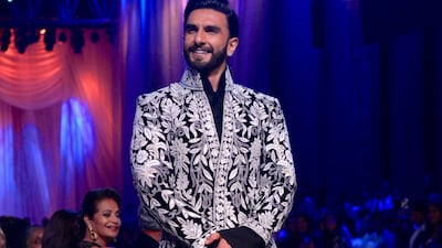 Singh wore a black sherwani with white embroidery and black trousers that complemented Padukone's look.