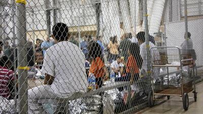 People who've been taken into custody related to illegal entry cases into the United States sit in one of the cages at a facility in McAllen, Texas. AP