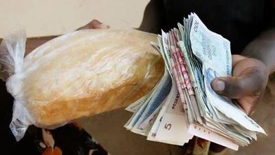 It took a lot of Zimbabwe dollar notes to buy a loaf of bread in September 2008. But in 2009 hyperinflation was eased by a reliance on the US greenback. Desmond Kwande / AFP
