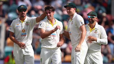 Australia's Pat Cummins celebrates with teammates after taking the wicket of England opener Zak Crawley for 18. AP