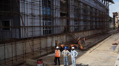 Men work at the National Arts Theatre stop of the Blue Line of the light rail system under construction by China Civil Engineering Construction Corporation. Joe Penney / Reuters
