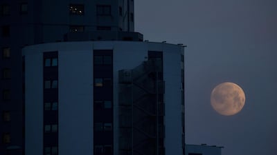The supermoon hangs low in the sky in Barcelona, Spain. EPA