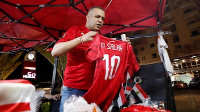 A trader holds up a replica shirt of Egypt's Mohamed Salah. Reuters