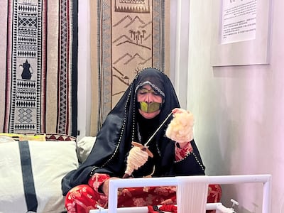 Emirati craftswoman Umm Salem at the UAE pavilion. Saeed Saeed / The National