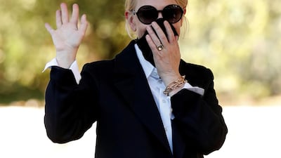 Cate Blanchett waves while covering her face as she arrives the day before the start of the 77th Venice International Film Festival on September 1, 2020. Reuters