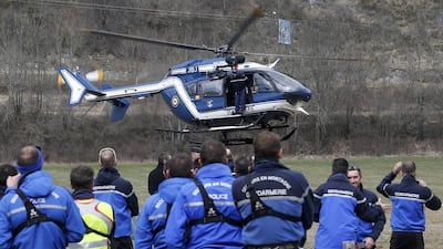 French Police and Gendarmerie Alpine rescue units gather on a field as they prepare to reach the crash site. Jean-Paul Pelissier /Reuters