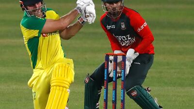 Australia's Mitchell Marsh plays a shot as Bangladesh's wicket-keeper Nurul Hasan looks on.