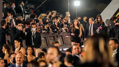 Photographers take photos during the opening ceremony of the 42nd Cairo International Film Festival. Reuters