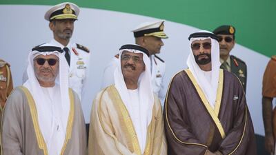 Dr Anwar bin Mohamed Gargash, UAE Minister of State for Foreign Affairs, HDr Abdullah bin Mohammed Al Nuaimi, UAE Minister of Public Works, and Mohammed Ahmad Al Bowardi, Under Secretary of the UAE Ministry of Defence, attend a flag raising ceremony in celebration of the UAE’s 43rd National Day, at the Breakwater in Abu Dhabi. Donald Weber / Crown Prince Court - Abu Dhabi