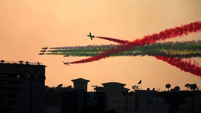 The Al Fursan aerobatic team flies over Dubai Media City as part of the World Air Games in Dubai. Jon Gambrell / AP Photo