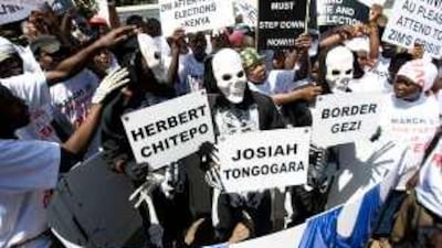 Demonstrators hold signs of Zimbabwe's dead leaders' names at a rally.